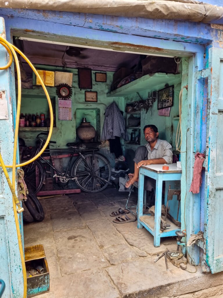 image of a man sitting inside his shop in Jodhpur captured by Jainish Soni