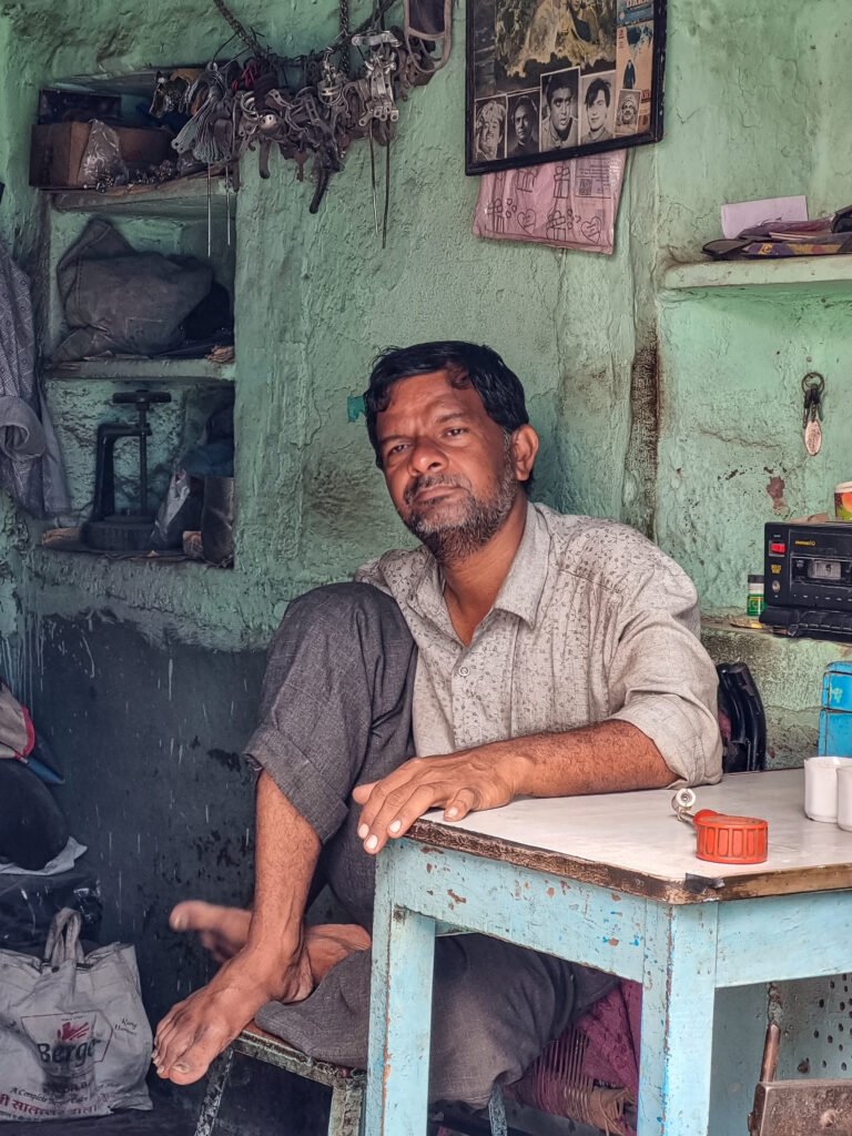 portrait of a man sitting inside his shop in Jodhpur captured by Jainish Soni