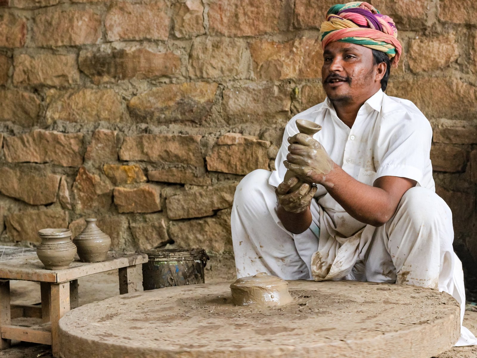 a closeup image of a man making a pot in Jodhpur captured by Jainish Soni
