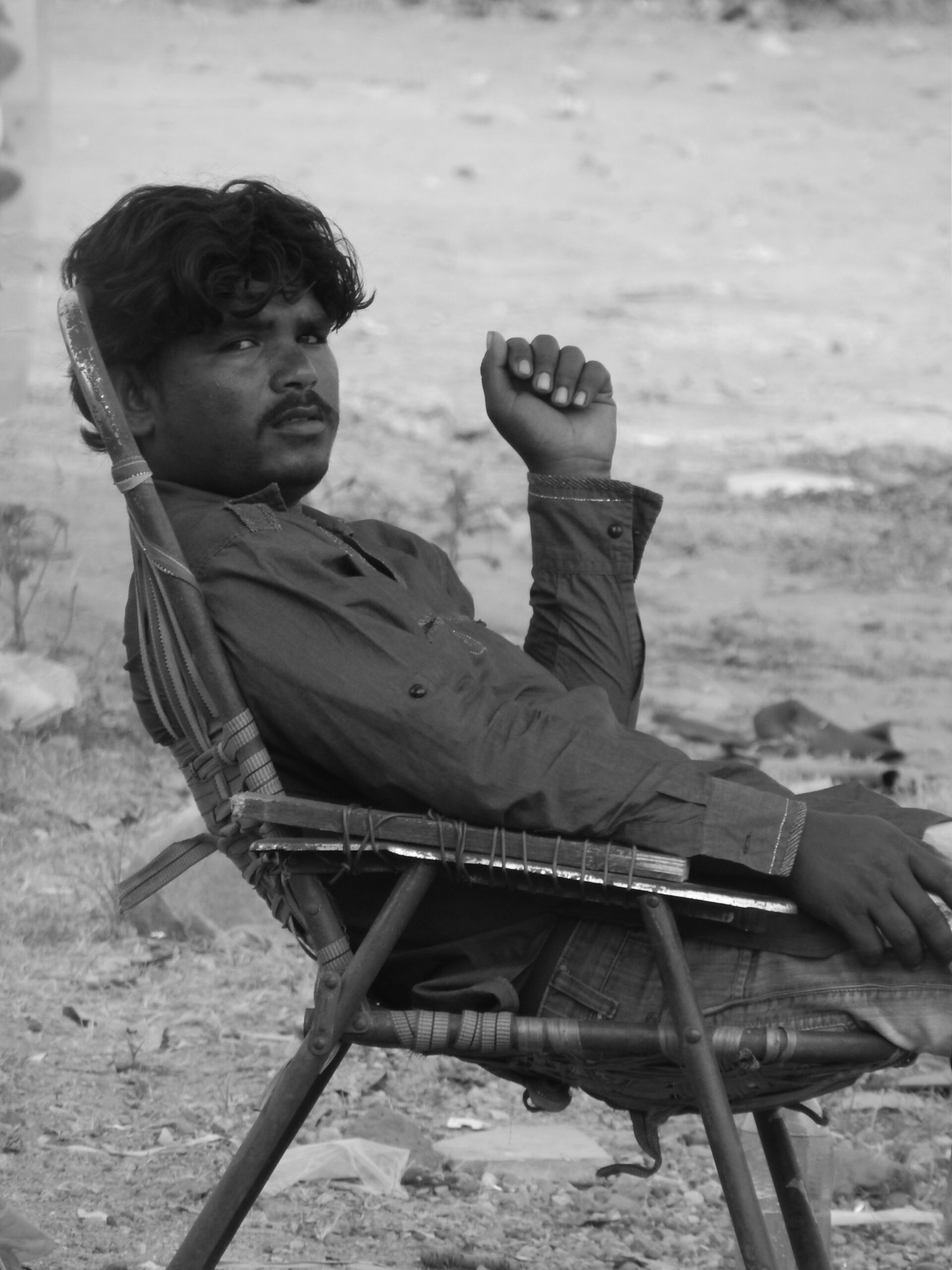 image of a man sitting on a street captured by Jainish Soni