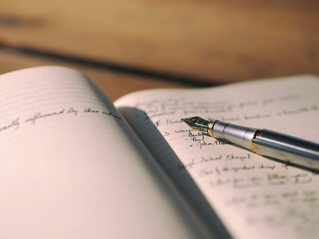 Notebook and pen representing Jainish Soni's accessibility, project management, and marketing writing